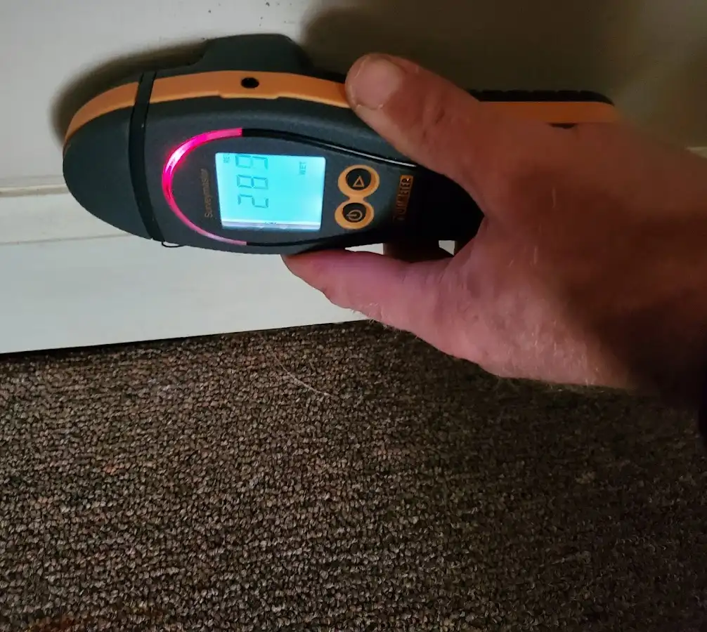 Moisture detection at baseboard during Storm Damage Restoration in Tustin